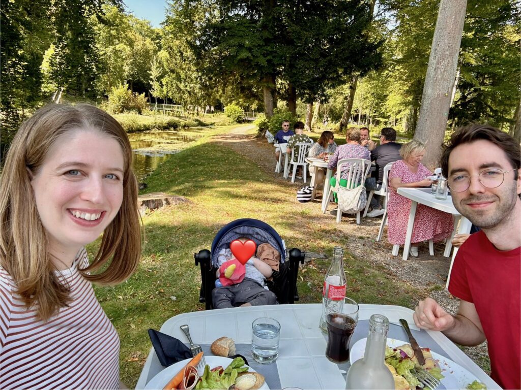 Family enjoying lunch outside at Le Hameau restaurant on the Chantilly castle grounds